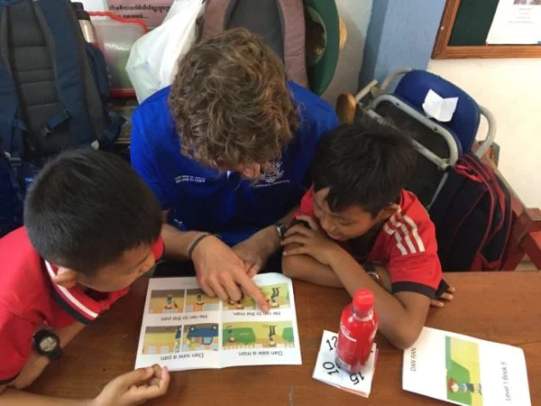 Group of students working on a project together in a classroom setting.