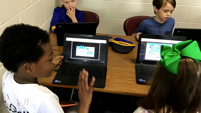Matilda Harris playing Word Mania on a digital device.